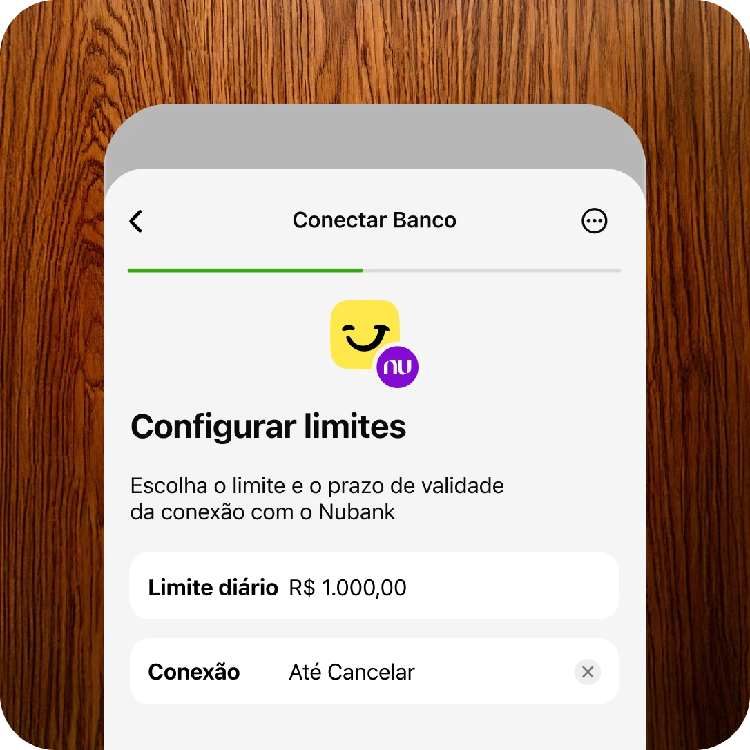 Imagem de interface de conexão entre o Jota e o banco Nubank, com opção de configurar limite diário de R$ 1.000,00 e duração da conexão como “Até Cancelar”. Tela com fundo de madeira ao redor e layout limpo.