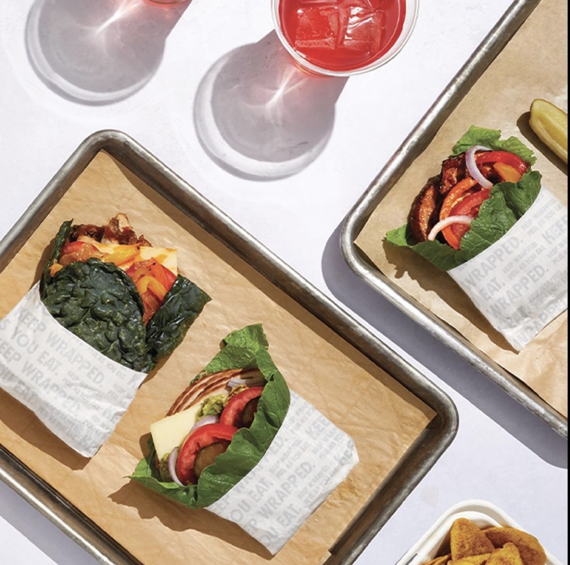 Breadless menu items: sandwiches wrapped in leafy supergreens
