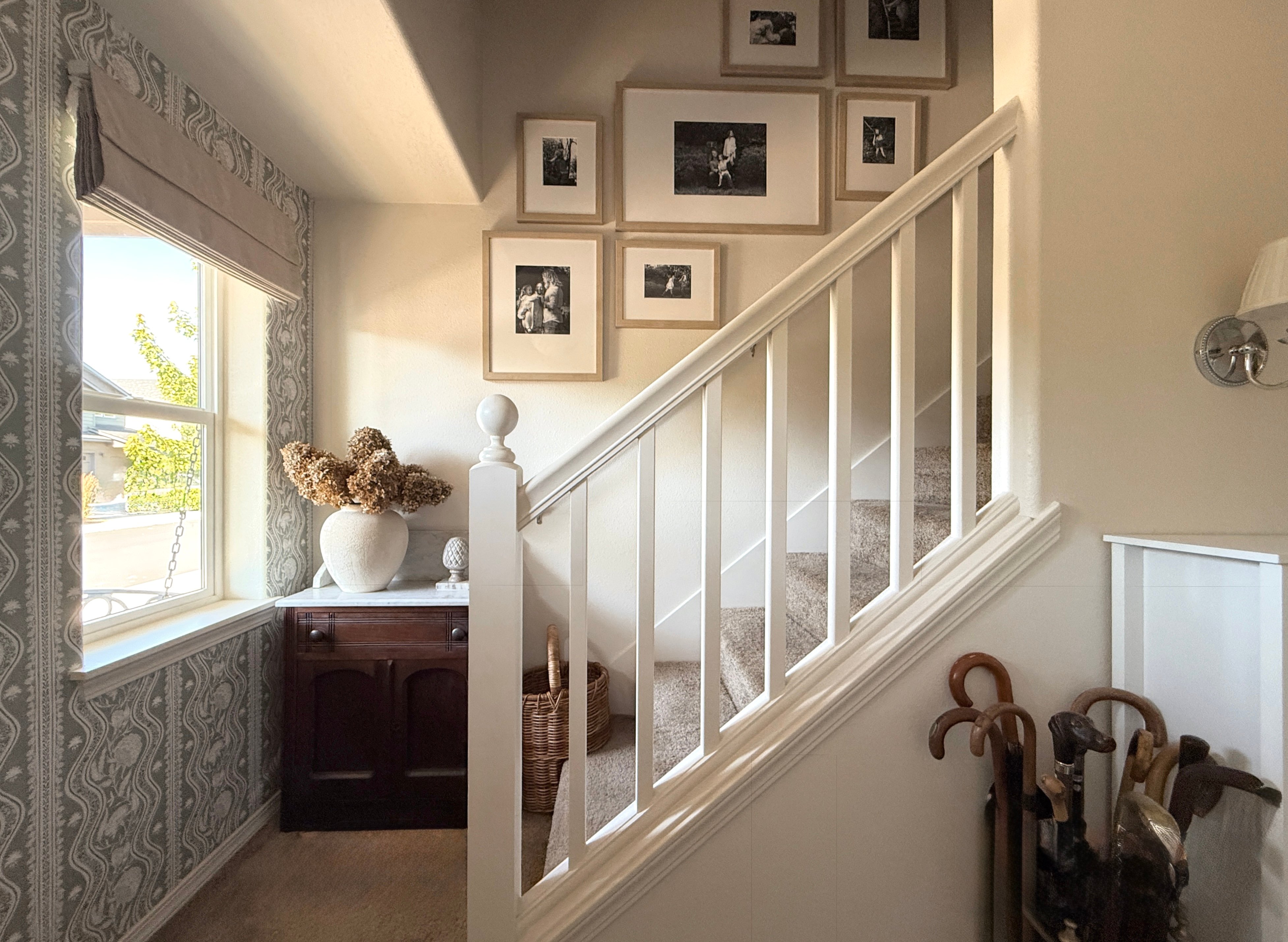 Frameology's Luxe Staircase gallery wall seen from an entryway