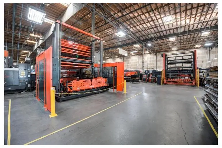 Powder-coating and material-handling racks on the Fabcon shop floor.