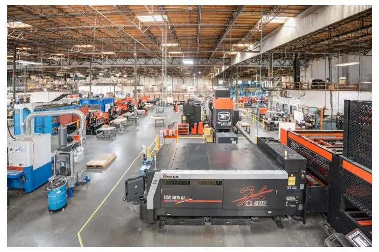 A large laser cutting machine on the Fabcon fabrication floor.