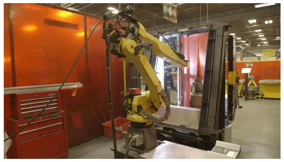 A robotic automation cell handling metal parts on the Fabcon floor.