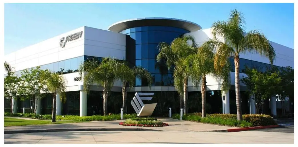 The exterior of the Fabcon headquarters building with the company sign and palm trees.