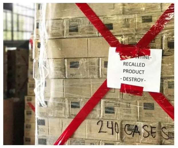 A shrink-wrapped pallet of boxes marked Quarantine, Recalled Product, Destroy.