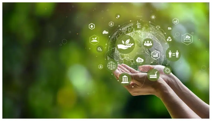 Two hands holding a globe surrounded by green sustainability and circular-economy icons.