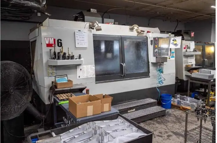 A precision machine shop floor with CNC equipment and work cells.