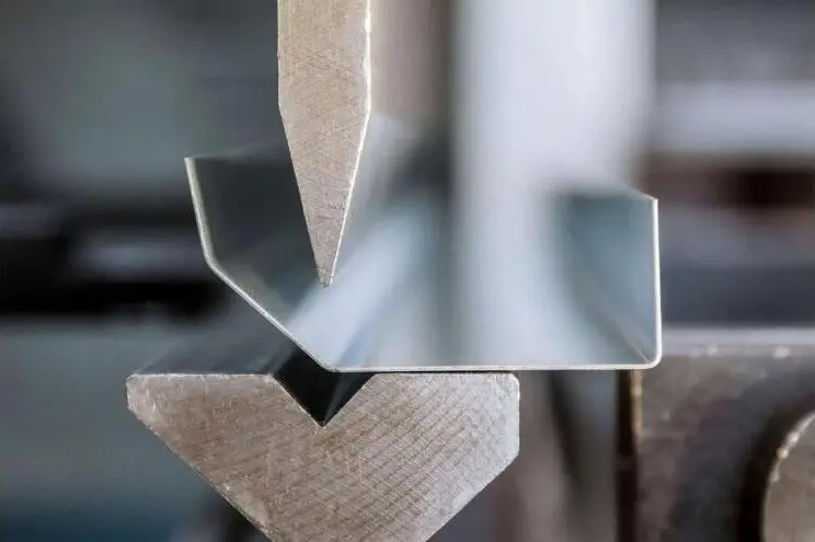 A press brake forming a sheet metal bracket.