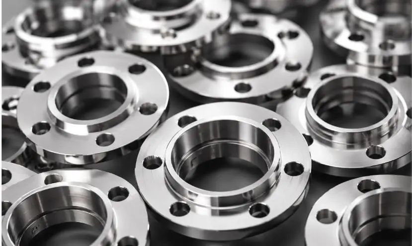 Machined metal flanges arranged after finishing and deburring.
