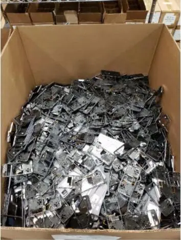 A large cardboard gaylord box filled with reclaimed device housings for recycling.