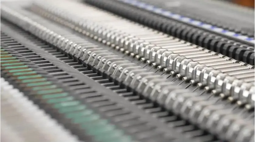Macro view of dense rows of electronic components and interconnects on a board.