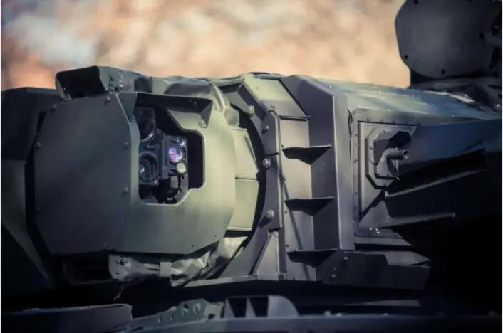 A military armored vehicle with a mounted electro-optical sensor system.