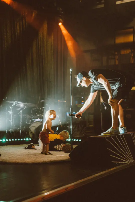 A wide shot of a live show, stage and audience together.