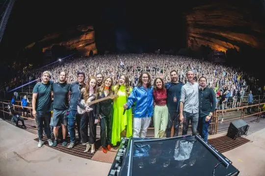 Concertgoers gathered at an outdoor venue overlooking the crowd.