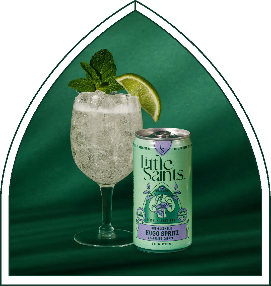 A Little Saints Hugo Spritz can beside the poured spritz cocktail with mint and lime.