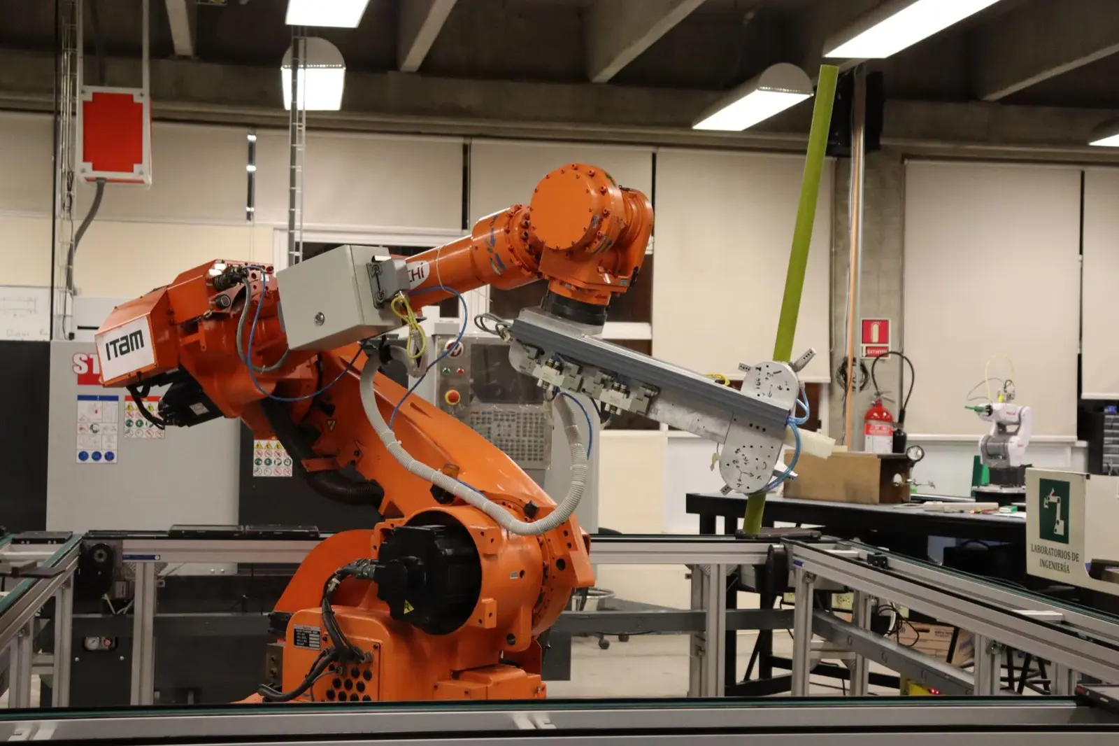 Industrial robotic arm working on a metal part in an automated manufacturing cell
