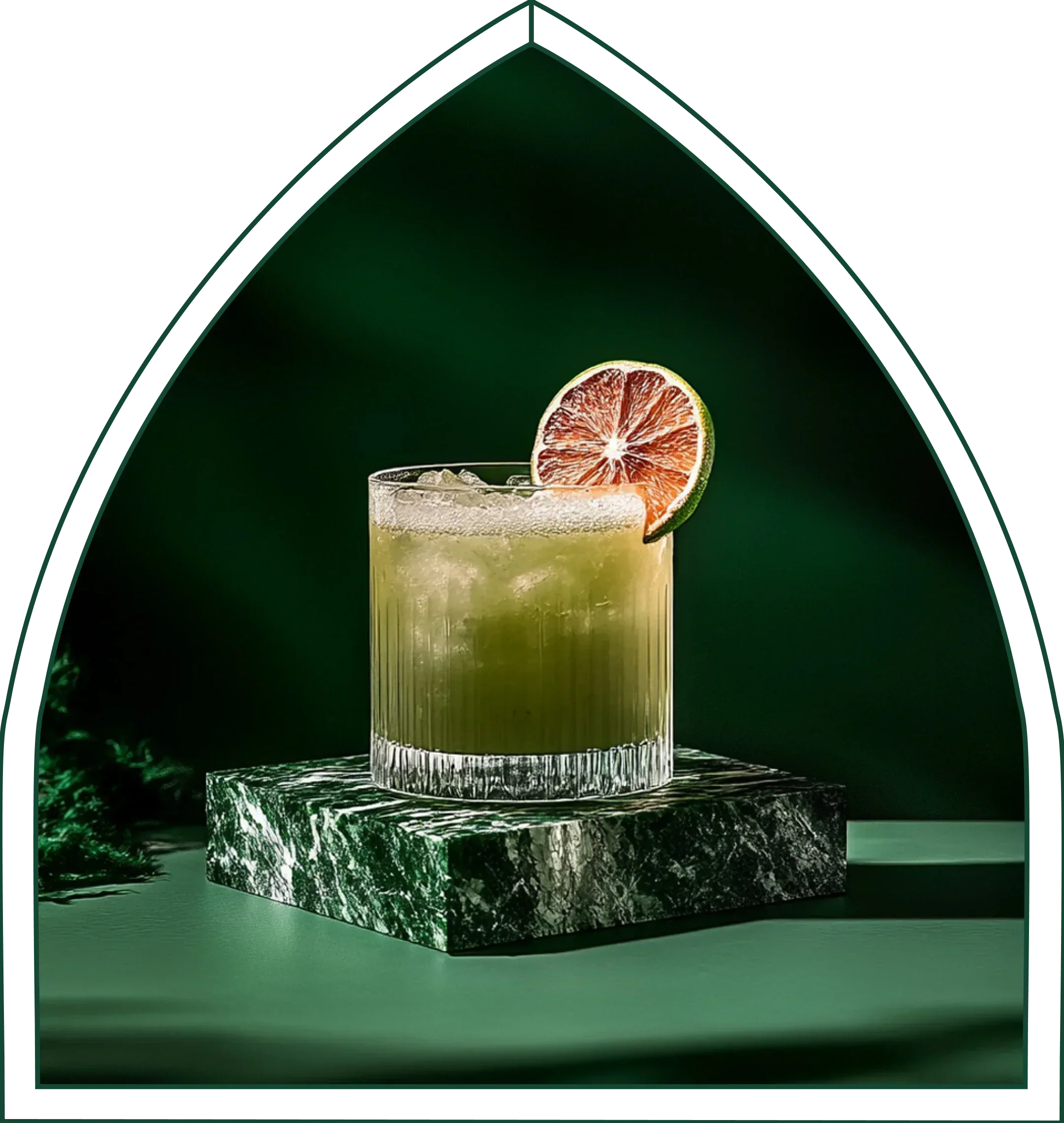 A refreshing green non-alcoholic cocktail with a lime wheel on green marble, in Little Saints' arch style.